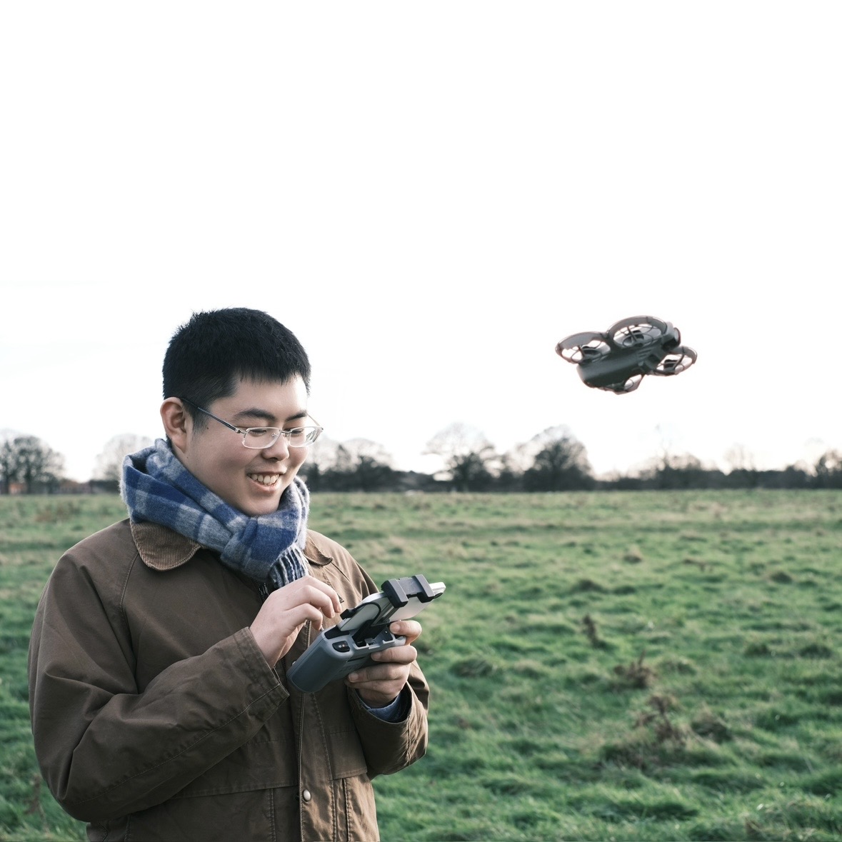 Xihao Zhang operating a drone in an open field